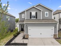Charming two-story home featuring a two-car garage and well-maintained landscaping at 63 White Ash Dr, Clayton, NC 27527