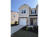 Charming two-story home with a modern design, stone accents, and a one-car garage at 6332 Andante Ave, Raleigh, NC 27616