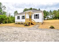 Charming single-story home with white siding, black shutters, and a cozy front porch at 68 S Grace Way, Henderson, NC 27537