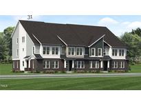 New townhome exterior showcasing brick and siding with a well-manicured lawn at 811 Fireship Rd, Fuquay Varina, NC 27526