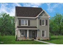 Charming two-story home with a traditional design, landscaped yard, and covered entry at 813 Fireship Rd, Fuquay Varina, NC 27526