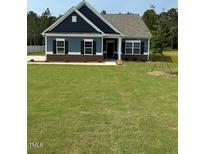 Charming single-story home with blue siding, black shutters, and a well-manicured lawn at 95 Knoll Way, Sanford, NC 27332