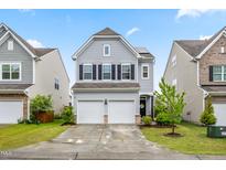 Charming two-story home with a two-car garage, landscaped yard, and welcoming front porch at 1018 Sweet Cream Ct, Durham, NC 27703