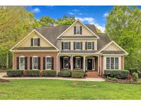 Charming two-story brick home with manicured lawn and landscaping at 124 Mantle Dr, Clayton, NC 27527