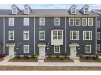 Charming townhome with gray siding, multiple windows and light green doors at 139 Callowhill Ln, Durham, NC 27713