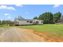 Charming single-story home with a covered porch and well-maintained lawn at 1729 Crawford Rd, Graham, NC 27253