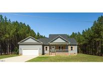 Charming single-story home with a manicured lawn and attached garage at 1730 Willie Pace Rd, Burlington, NC 27217