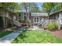 Charming brick townhouse with landscaped yard, sidewalk, and inviting entrance stairs at 200 W Woodcroft Pkwy # 45C, Durham, NC 27713