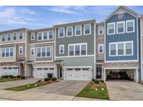 Charming townhomes feature varied color schemes, attached garages, and manicured front lawns with lush landscaping at 2313 Bay Minette Sta # 543, Apex, NC 27502
