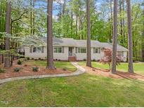 Charming ranch-style home with a stone pathway leading to the front door and lush landscaping at 2805 Chelsea Cir, Durham, NC 27707