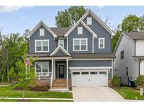 Beautiful two-story home with a manicured lawn, a two-car garage, and an inviting front porch at 33 Highpointe Dr, Pittsboro, NC 27312
