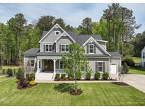 Beautiful two-story home featuring a landscaped front yard and charming front porch at 3545 Donlin Dr, Wake Forest, NC 27587