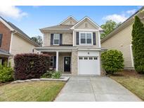 Charming two-story home featuring a well-maintained yard and attached garage at 3811 Yates Mill Trail, Raleigh, NC 27606