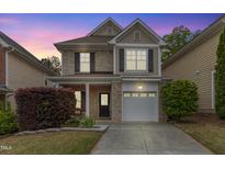 Charming two-story home with brick and siding, featuring a driveway and well-maintained landscaping at 3811 Yates Mill Trail, Raleigh, NC 27606