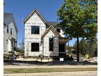 Exterior view of a new two story home under construction with black framed windows and yard at 3817 Coach Lantern Ave, Wake Forest, NC 27587