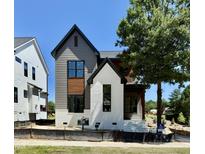 Beautiful new construction featuring a blend of gray siding and white brick, accented by modern black trim at 3817 Coach Lantern Ave, Wake Forest, NC 27587