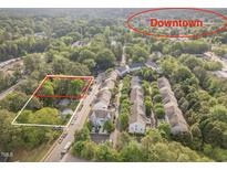 An aerial view of the property showing proximity to Downtown Cary, neighborhood streets, and surrounding lush greenery at 408 Madison Ave, Cary, NC 27513