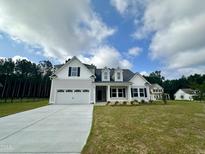 Charming two-story home featuring a two-car garage and beautifully landscaped front yard at 427 Earnest Way # L24, Kenly, NC 27542