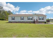 Charming single-story home with a well-manicured lawn and inviting front porch at 7228 Lowery Meadow Dr, Wendell, NC 27591