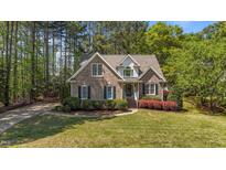 Charming brick home featuring manicured landscaping and mature trees in a desirable neighborhood at 903 Oldwyck Dr, Fuquay Varina, NC 27526
