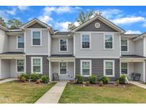 Charming townhome with gray vinyl siding, well-manicured landscaping, and inviting walkway at 918 E Green St # F105, Franklinton, NC 27525