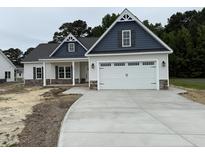 Charming two-story home with a spacious two car garage and a well-manicured lawn and inviting front porch at 1000 Peedin Rd, Selma, NC 27576