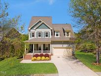 Charming two-story home with a well-manicured lawn and inviting front porch at 1093 Trentini Ave, Wake Forest, NC 27587