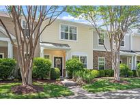 Charming townhome with stone accents and well-maintained landscaping under a blue sky at 11210 Lofty Heights Pl, Raleigh, NC 27614