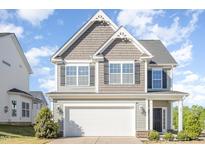 Charming two-story home with a two-car garage and attractive architectural details at 12 Douglas Fir Pl, Clayton, NC 27520