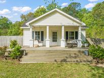Charming home featuring a spacious front porch with swing, perfect for enjoying the outdoors at 12601 Boyce Mill Rd, Raleigh, NC 27613