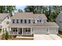 Charming two-story home with a welcoming porch and a spacious two-car garage, complete with manicured landscaping at 1265 Meadow Queen Ln, Apex, NC 27502