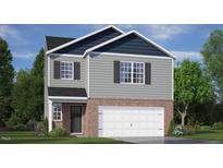 Charming two-story home with gray siding, brick accents, and a two-car garage, set against a blue sky at 152 Global Ave, Fuquay Varina, NC 27526
