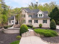 Elegant brick home boasts manicured landscaping and a welcoming front entrance at 16106 Morehead, Chapel Hill, NC 27517