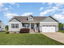 Charming single-Gathering home with two-car garage, manicured lawn, and lovely landscaping at 173 Silver Tee Ct, Selma, NC 27576