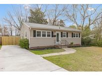 Charming single-story home with a well-maintained front yard, concrete driveway, and welcoming entrance at 2014 Walnut St, Durham, NC 27705