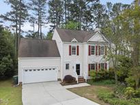 Charming two-story home with red shutters and a well-manicured lawn at 207 Ashley Brook Ct, Cary, NC 27513