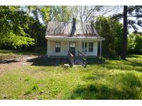 Exterior of home with a small porch, roof and yard with trees at 223 Gum Ave, Spring Hope, NC 27882