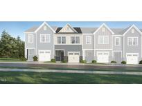 Charming townhome with a front-entry two car garage and stone accents at 236 Paramount Dr, Smithfield, NC 27577