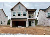 New two-story home featuring a spacious garage and covered porch awaiting finishing touches at 255 Meadowbark Bnd # 31, Garner, NC 27529