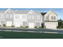 New townhome with stylish vertical siding, stone accents, attached garage, and tasteful landscaping at 385 Thompson Overlook Way, Smithfield, NC 27577
