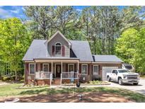 Charming two-story home with a welcoming front porch and well-maintained landscaping at 604 Young Forest Dr, Wake Forest, NC 27587