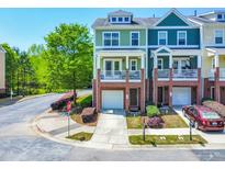 Charming townhome with a brick front, balcony, and attached garage on a cul-de-sac street at 705 Samuel Cary Dr, Cary, NC 27511