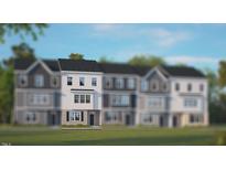 Charming townhome with black door, set against lush lawn and bright sky at 764 Dorset Stream Dr, Fuquay Varina, NC 27526