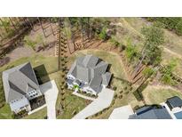 Stunning aerial view of home nestled on a lush lot with mature trees and impeccable landscaping at 8208 Bella Oak Ct, Wake Forest, NC 27587