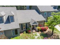 Charming home exterior with a covered entry, blooming azaleas and lush landscaping at 918 Albany Ct, Raleigh, NC 27615
