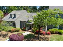 Charming home with beautiful landscaping featuring mature trees and colorful flowering bushes enhancing curb appeal at 918 Albany Ct, Raleigh, NC 27615
