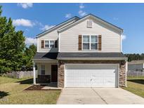 Charming two-story home featuring a two-car garage and well-maintained front lawn at 929 Mailwood Dr, Knightdale, NC 27545