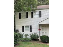 Charming two-story home with white siding, black shutters, and well-maintained landscaping at 1045 Nichols Dr, Raleigh, NC 27605