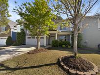 Charming two-story home featuring a well-manicured lawn and a two-car garage at 108 Warm Wood Ln, Apex, NC 27539