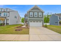 Charming two-story home with a two-car garage and a welcoming pink front door at 1501 Addison Lake St, Fuquay Varina, NC 27526